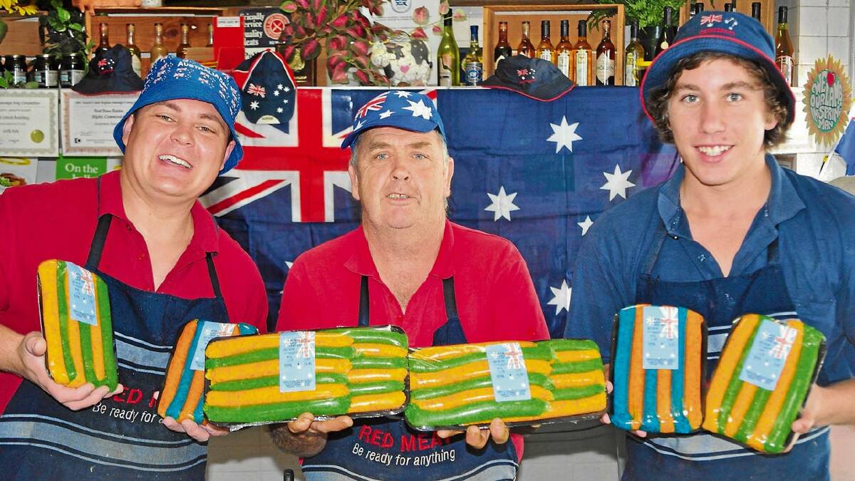 PATRIOTIC: The team from the North Nowra Butchery (from left) Thor Cantarakis, owner Wayne Kennedy and Joel Mitchell show off their latest creations for Australia Day, green and gold and red and blue sausages.