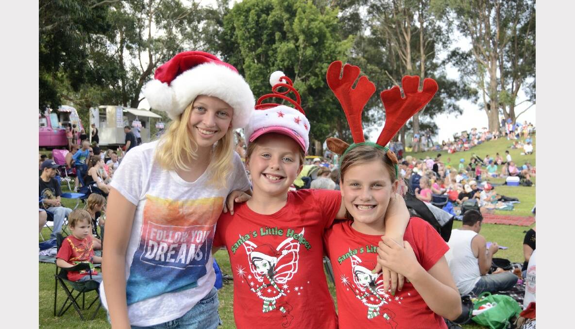 FESTIVE: Emily Laing, Zoe Baker and Amy Baker all from St Georges Basin dressed for Carols by Candlelight in Harry Sawkins Park on Sunday.