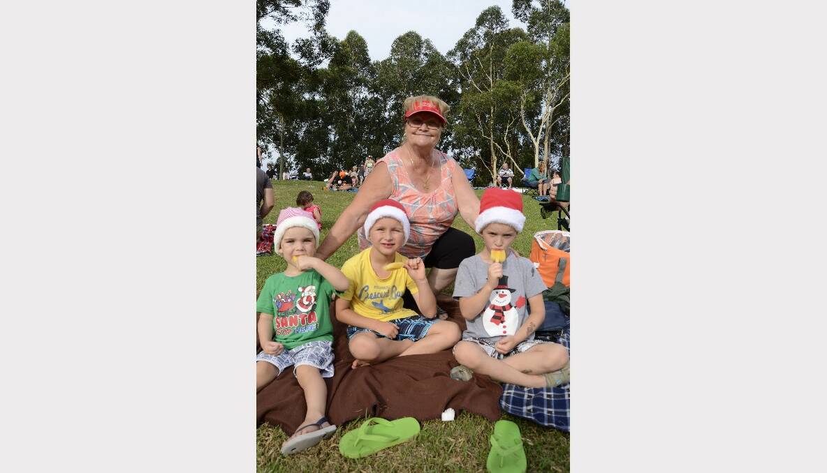 CAROLS WITH NAN: Cody, Tyson and Noah Walker from Berry out at Carols By Candlelight with their grandmother Sally Dalto from North Nowra.