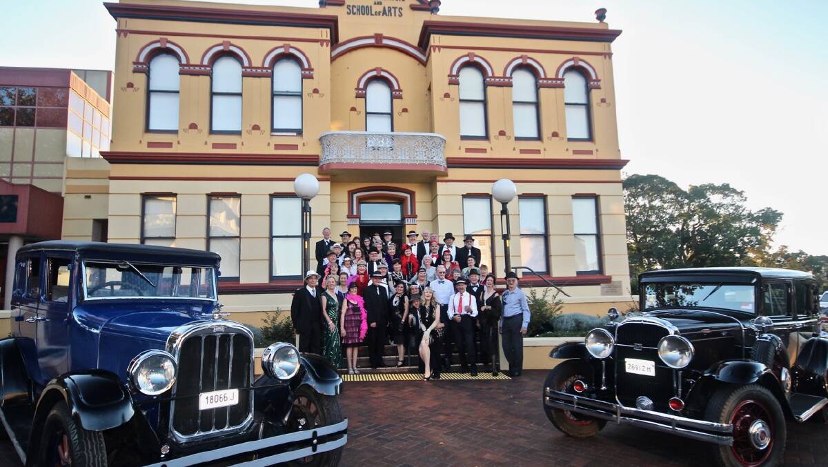 NIGHT OF FUN: The dancers, dressed in their 1920's outfits, posed in front of a 1930s Buick and a 1926 Chandler.