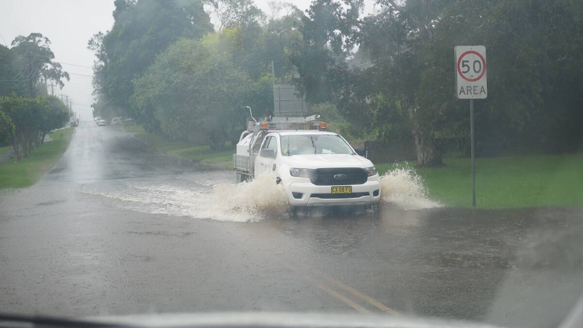 FLASH FLOODING: A motorist in Gerringong driving through flash flooding.