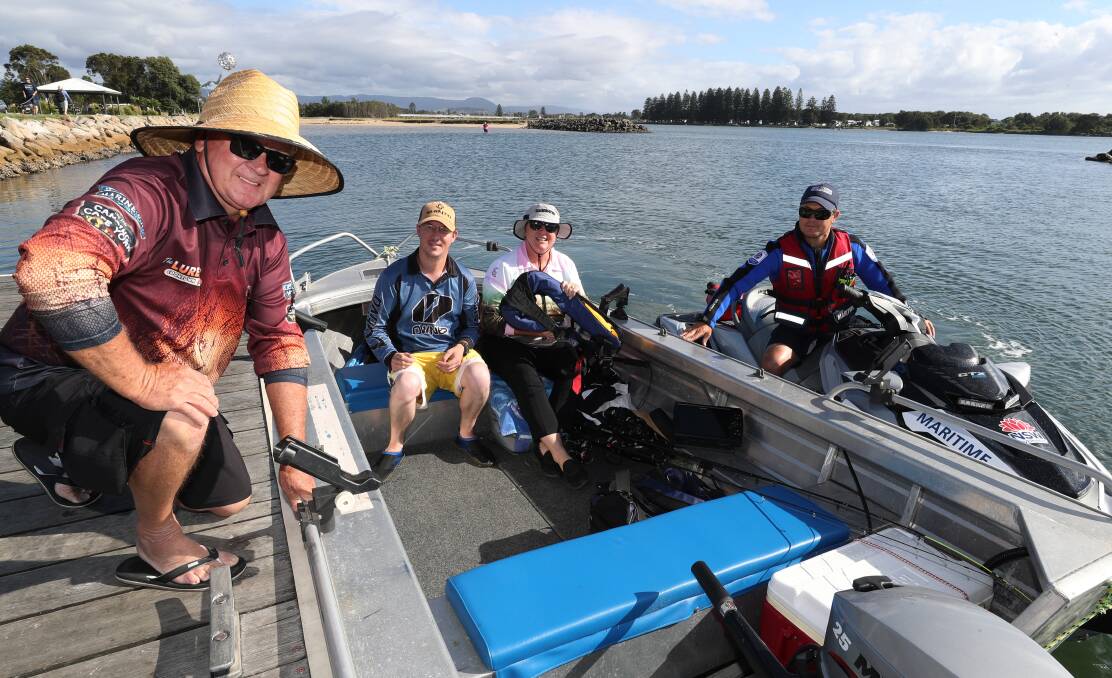 Safety checks: Luke Macdonald boating safety officer for Wollongong - NSW Maritime talking with Peter Feutrill, Chris Feutrill and Jill Feutrill from Kiama. Picture: Robert Peet