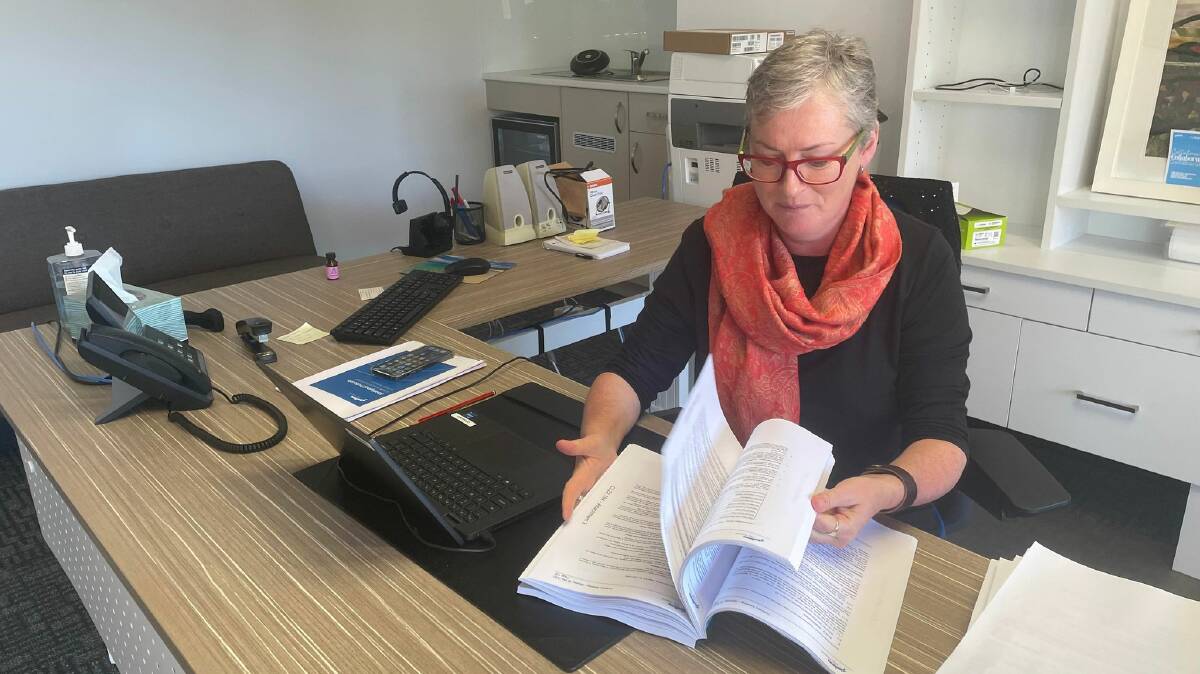 Have your say: Shoalhaven Mayor Amanda Findley inspects counil's draft budget which councillors endorsed to put on public exhibition at an ordinary meeting earlier this week. Picture: Grace Crivellaro.
