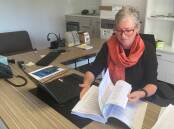 Have your say: Shoalhaven Mayor Amanda Findley inspects counil's draft budget which councillors endorsed to put on public exhibition at an ordinary meeting earlier this week. Picture: Grace Crivellaro.