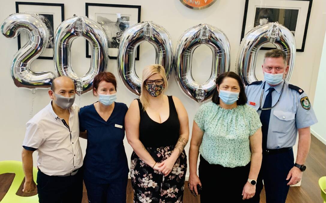 CELEBRATIONS: Practice Principals Dr Hao Pham and Annette Pham celebrating their 20,000th COVID-19 dose administered, with recipient Melissa Carlsson, Gilmore MP Fiona Phillips and Nowra Police Station Inspector Ray Stynes. Image: supplied. 