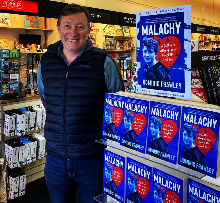 MALACHY: Dr Dominic Frawley with his published book Malachy on the shelves of Dymocks Nowra. Image: supplied.
