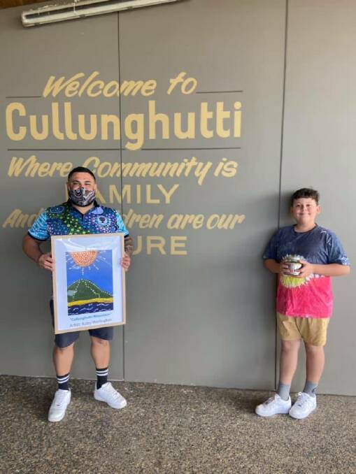 MAKING A DIFFERENCE: After selling his paintings, 11-year-old Koby Wellington presented a donation to Uncle Charlie at Cullunghutti Aboriginal Childcare and Family Centre on Thursday. Image: supplied.
