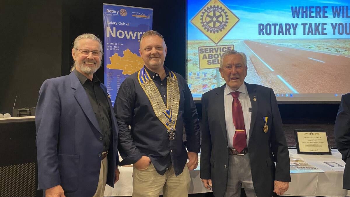 86 YEARS: Area Governor Adam de Totth, Nowra Rotary President Jason Cox and club member Arthur Moorhouse celebrating at the Bomaderry Bowling Club. Image: Grace Crivellaro.