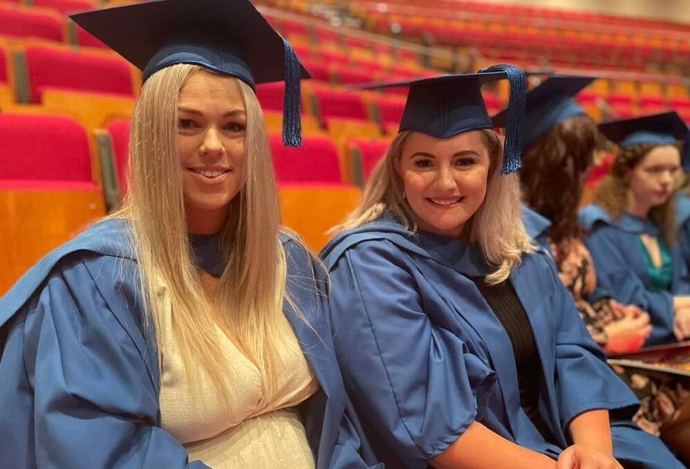 CELEBRATION: Nursing graduates Paige Ryall and Carolyn Samuel at UOW Shoalhaven's first graduation ceremony since the pandemic on Thursday. Picture: Grace Crivellaro.