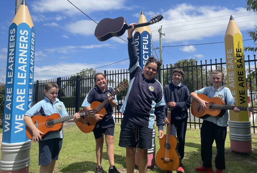 ROCK ON: Bomaderry Public School students were beaming with joy when gifted guitars they could keep for themselves from the Canberra-based Soldier On veterans group. Image: Grace Crivellaro.