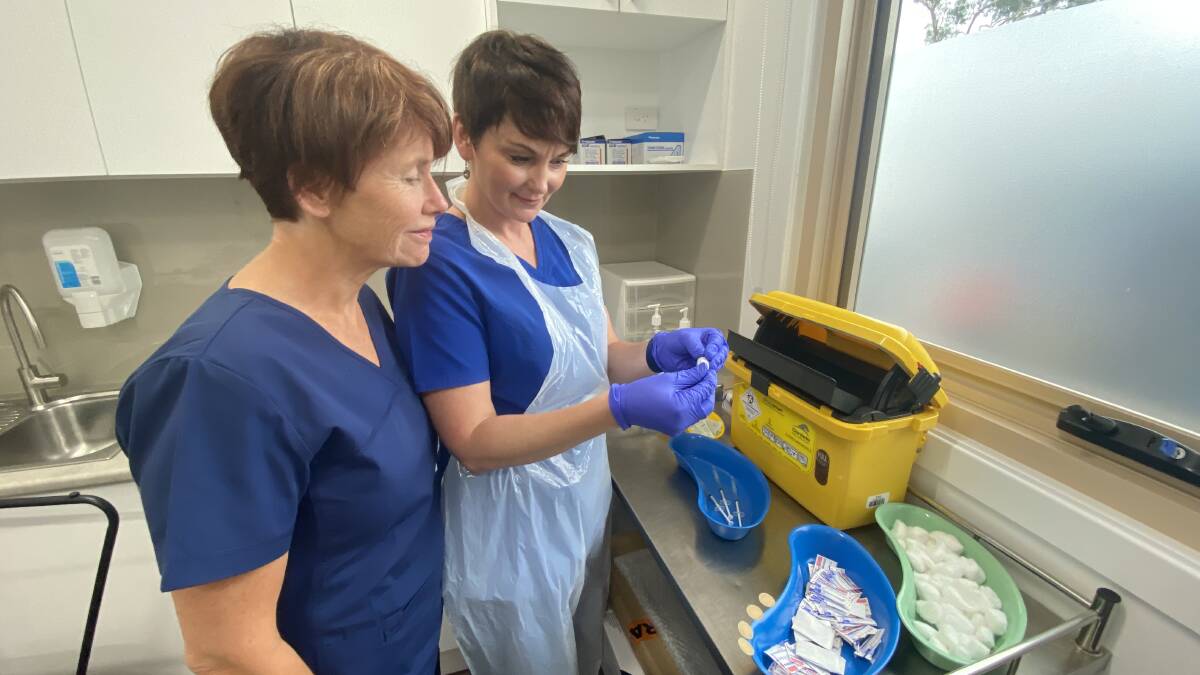 ROLLOUT: Nurses Annette Pham and Leanne Phillips preparing the first dose of the phase 1b vaccine. Image: Grace Crivellaro