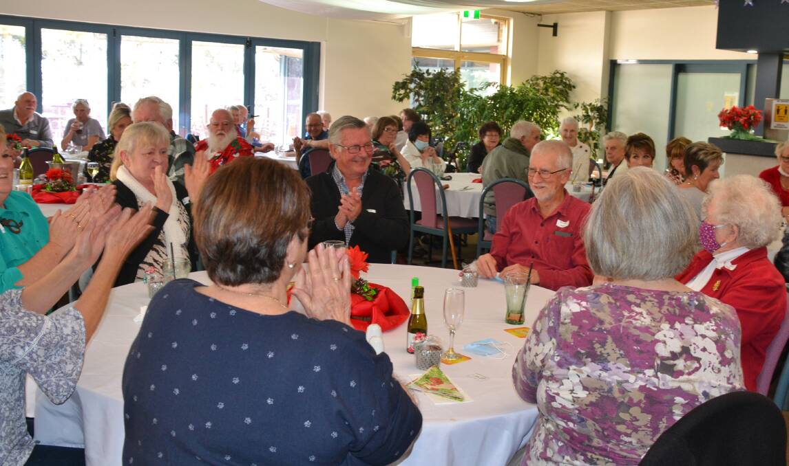 WINNER: Volunteer Rob Sears winning a raffle prize at the Jervis Bay Meals on Wheels Christmas in July celebration.