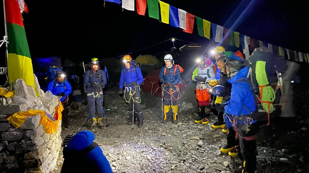The Fly from Everest team receiving a blessing before heading to the summit at 2am with the Sherpas. Picture: Joe Carter.