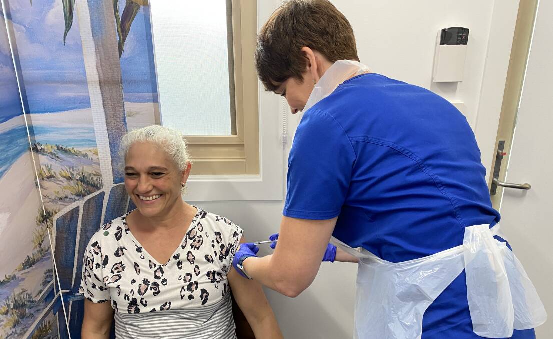 PLENTY TO GO AROUND: Vincentia Medical Centre nurse Leanne Phillips administering a dose of the AstraZeneca vaccine.