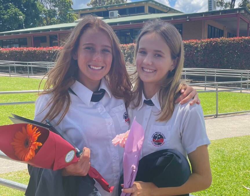 HIGH ACHIEVER: Currarong resident Emma Moore (right) with her friend Sienna Delacruz at their Nowra Anglican College graduation day last year. Image: supplied.