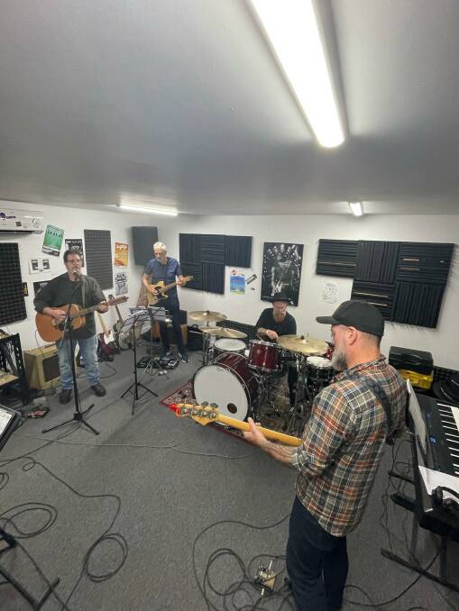 WATCH AND ACT: Nick Rheinberger and band members rehearsing for the Black Summer Rock Opera.