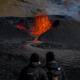 Tourists look at at lava flowing from a heart-shaped crater at the Fagradalsfjall volcano in Iceland on Monday, August 15, 2022. Photo: Aaron Chown/PA Images via Getty Images.