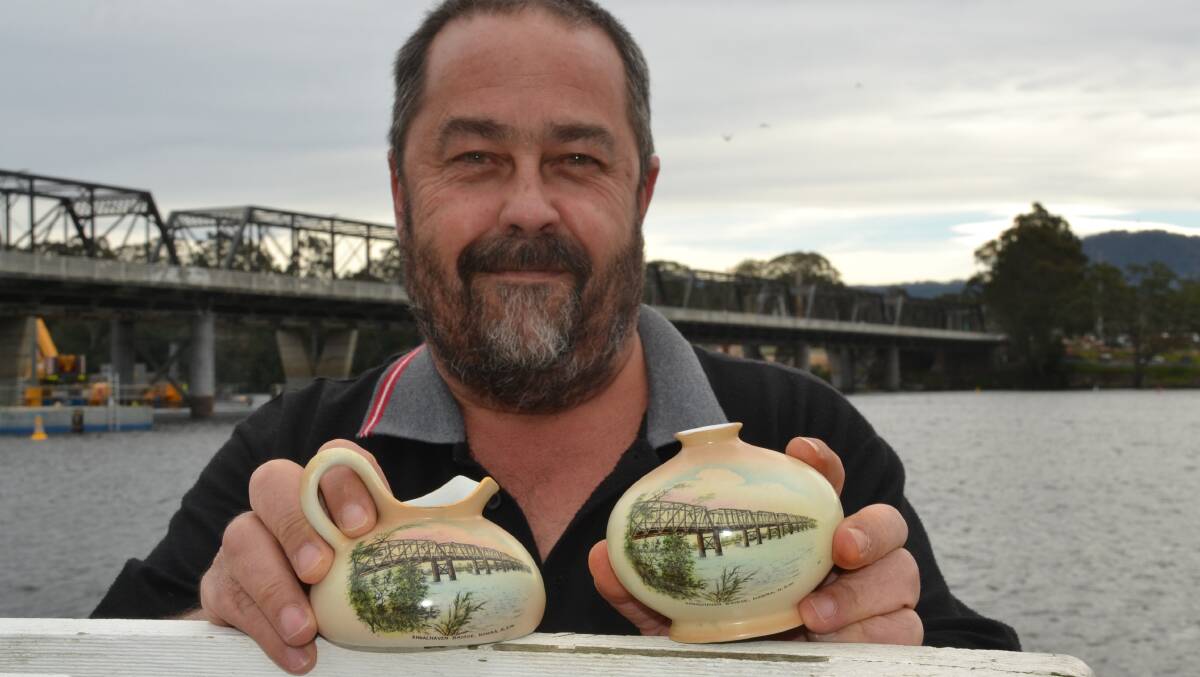 Shoalhaven collector Adam Manly with examples of early "souvenir ware" featuring paintings of the iconic original Nowra Bridge. Photo by Robert Crawford.