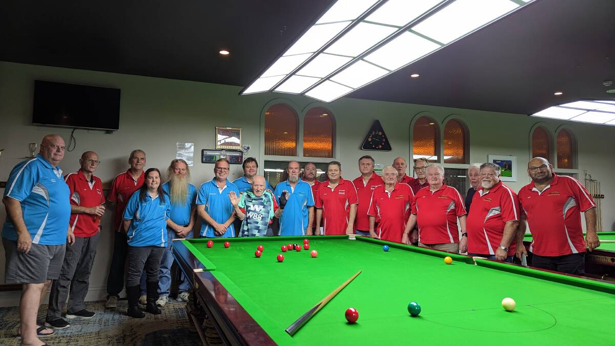 The St Georges Basin Snooker Club members pictured with one of the new tables. Picture by Sam Baker 