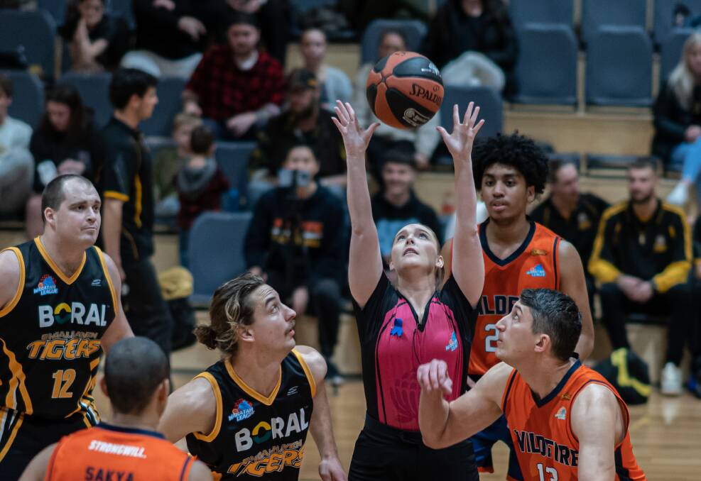 JUMP IT: Bruce Ozolins (Left) jumping for the tip last week in the Tigers win against the Wildfire. Picture: Shoalhaven Basketball Association. 