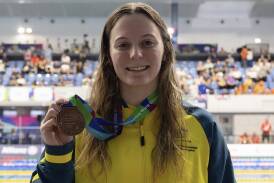 Jasmine Greenwood (pictured) posing with her bronze medal in the 100m butterfly. Picture supplied. 