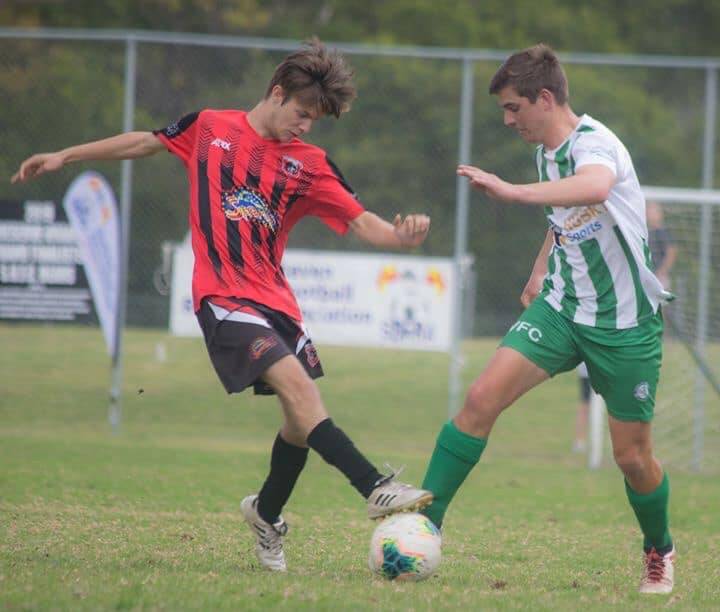 AN INTRIGUING BATTLE: Shoalhaven United F.C in a tussle against Huskisson F.C in a prior match. Photo: Robert Hawker. 