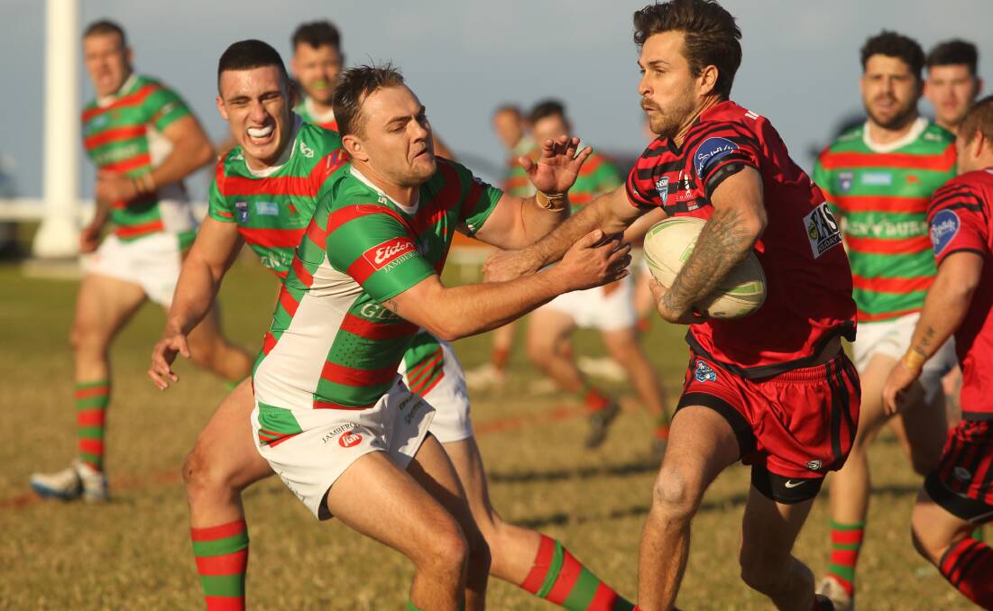 CLASH AT THE CASTLE: Kiama half-back and captain Tommy Atkins tried to evade the clutches of Jamberoo centre Matt Forsyth on Saturday. Photo: David Hall. 