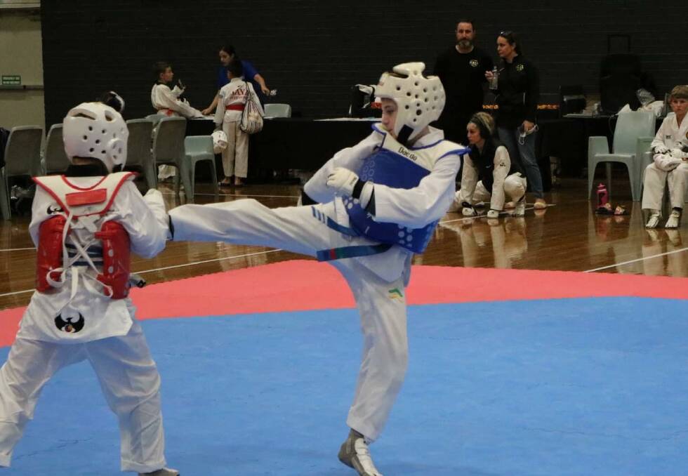 SUPERSTAR SHOWCASE: Carter Turner (Blue) delivers a high kick in a past Taekwondo event. Picture: Supplied