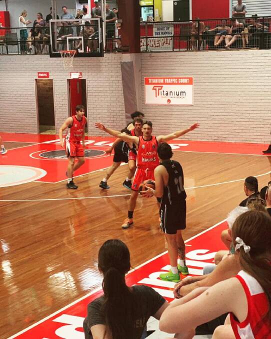 Brayden Morris (centre) getting his first taste of action for the Illawarra Hawks. Picture by Ben Morris.