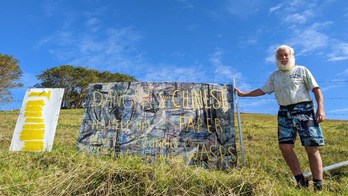 Dr Michael Hindmarsh (pictured) with his signposted fence-line outside of his Gerringong property. Picture by Sam Baker.