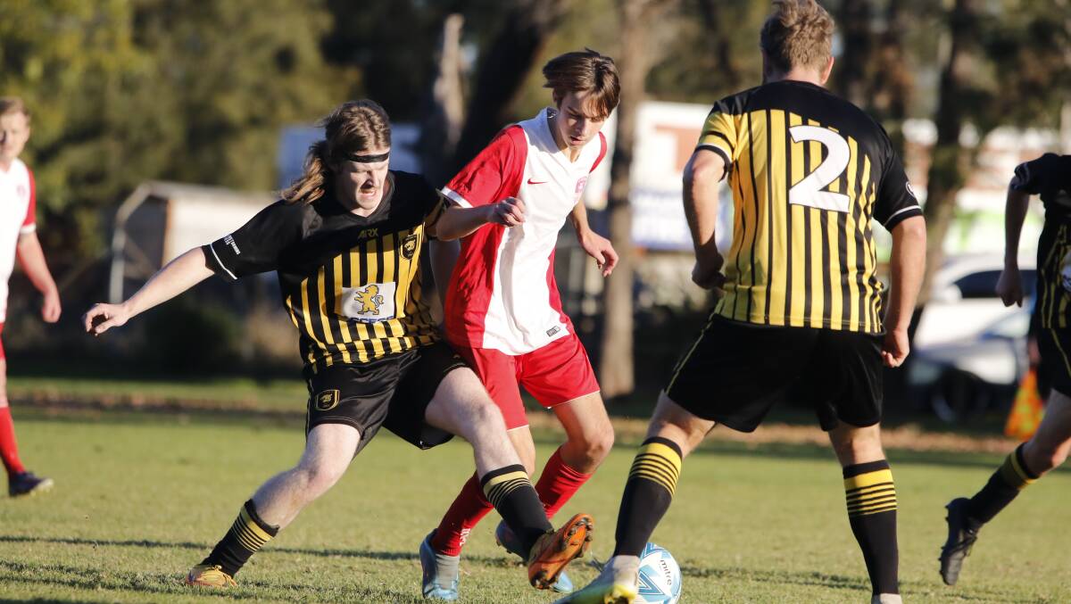 St Georges Basin's Rory Meyer doing his best to hold possession against Bomaderry. Picture by Tamara Lee.
