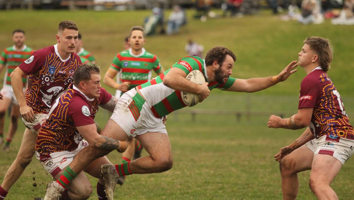 Jamberoo Superoos centre Paul Asquith tries to power through the tackle of Albion Park-Oak Flats halfback Kyle Williams during his side's 68-10 win on Saturday. Picture by David Hall