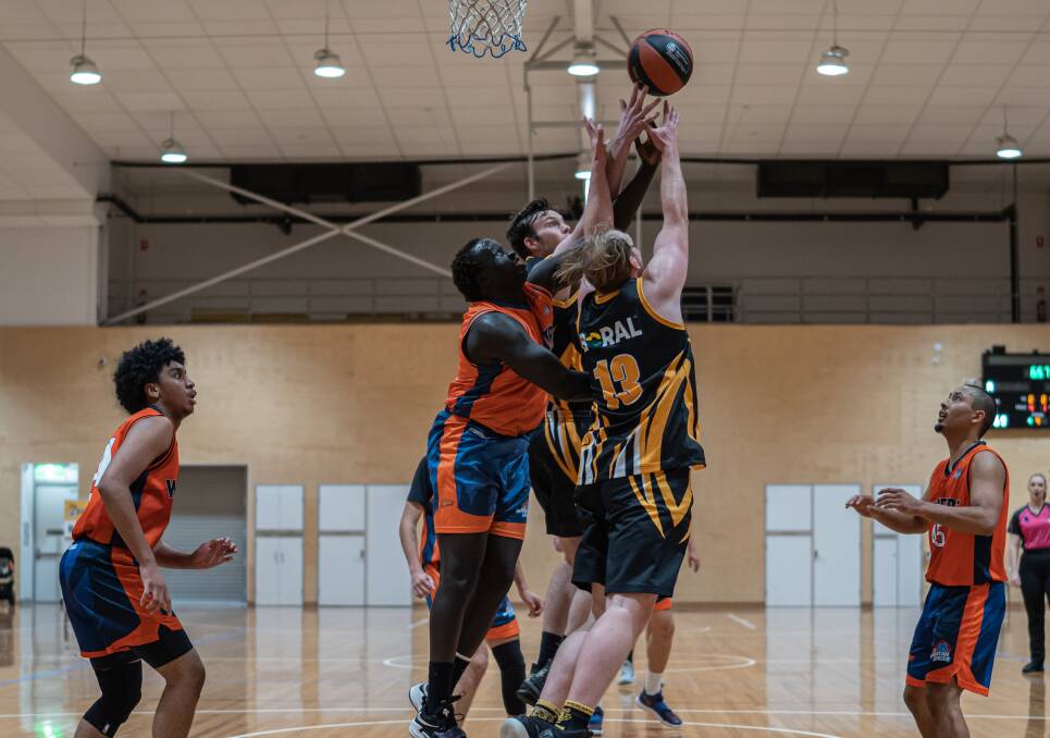 HUSTLE AND MUSCLE: Tigers' Dane Jensen #13 and Kyle Leslie #11 fighting for the offensive board against the Camden Valley Wildfire. Picture: Shoalhaven Basketball Association.