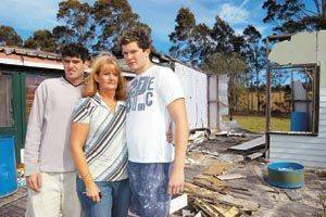 Carlene Timbs with sons Damien and Andrew, pictured outside their demolished house. A tree fell on the home in 1998, killing husband and father Gordon Timbs. Picture by Keeli Cambourne.