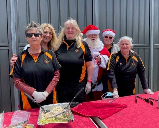 Workers and Bob Hanlon (Santa) handing out food to the homeless. Picture supplied.