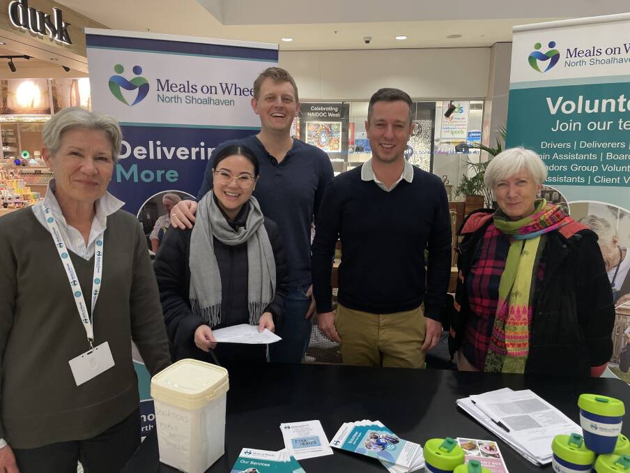 Sara Johnstone, new Meals on Wheels volunteer, with her husband Ryan and the Meals on Wheels team at the Stocklands stall. Picture: Tom McGann.