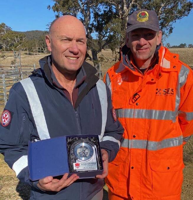 NSW Ambulance member, Jason Watson with his award for participating in NavShield for 30 years. Picture: Supplied. 