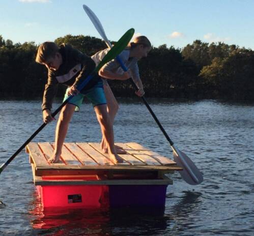 Ros Christie's grandchildren on a raft they built together during the holidays. Picture: Supplied. 