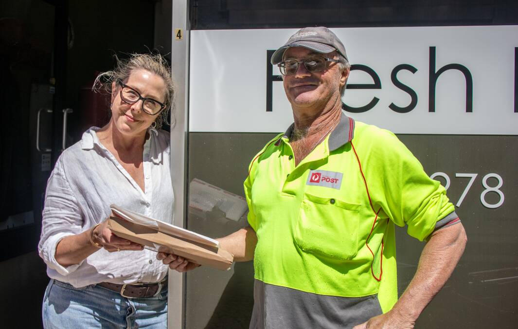 Nowra postie Lee Tompson delivers mail to Fresh Hair Designs' Jacki Korten. Picture by Jorja McDonnell.