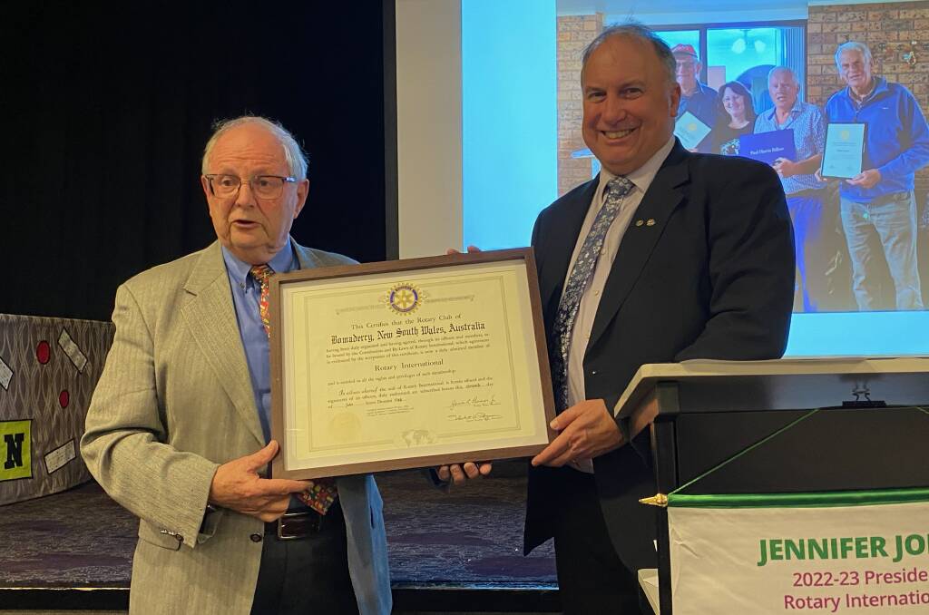 Bomaderry Rotary Club's last president Paul McLean-Williams (right) hands the club's charter back tp past district governor Bob Greeney. Picture by Glenn Ellard.