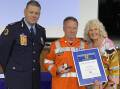 John Rigoni from the Nowra SES unit received an award recognising 40 years of service, presented by NSW SES Deputy Commissioner Daniel Austin and State Member for South Coast Liza Butler. Picture by Glenn Ellard.
