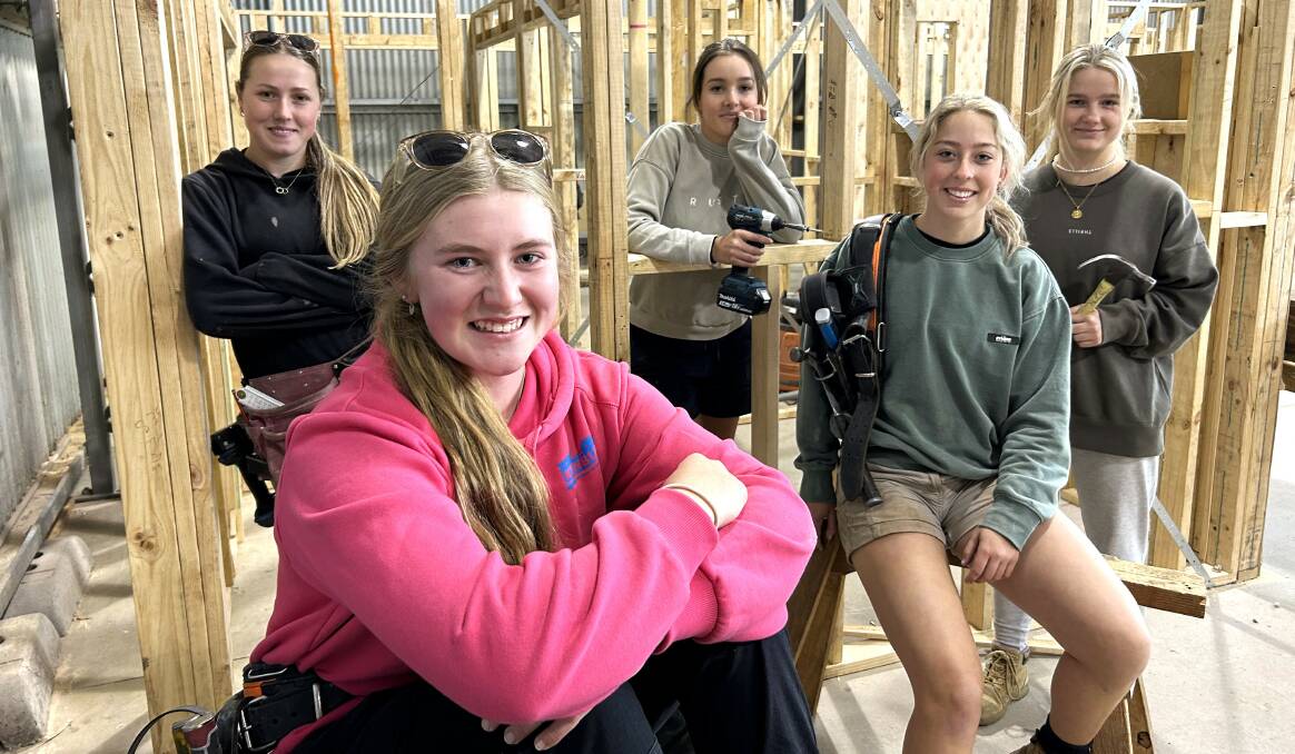Nowra TAFE apprentice carpenters from left, Tilhaney Grainger, Tasmyn Bendall, Aleyah Severino, Yasmin Anderson and Lilllian Stoertz say they love the variety, working outdoors and a sense of accomplishment of their jobs and training. Picture supplied.