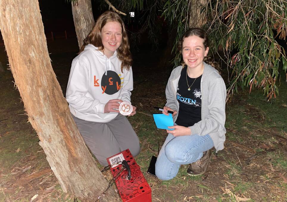 Sisters Maddy and Gaby Black hide a box in a secret location as part of the Sonder Youth scavenger hunt. Picture by Glenn Ellard.