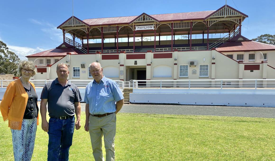 Nowra Show Society president James Thomson (centre) looks over the repainted pavilion and grandstand with former presidents Wendy Woodward ad Ralph Cook. Picture by Glenn Ellard.
