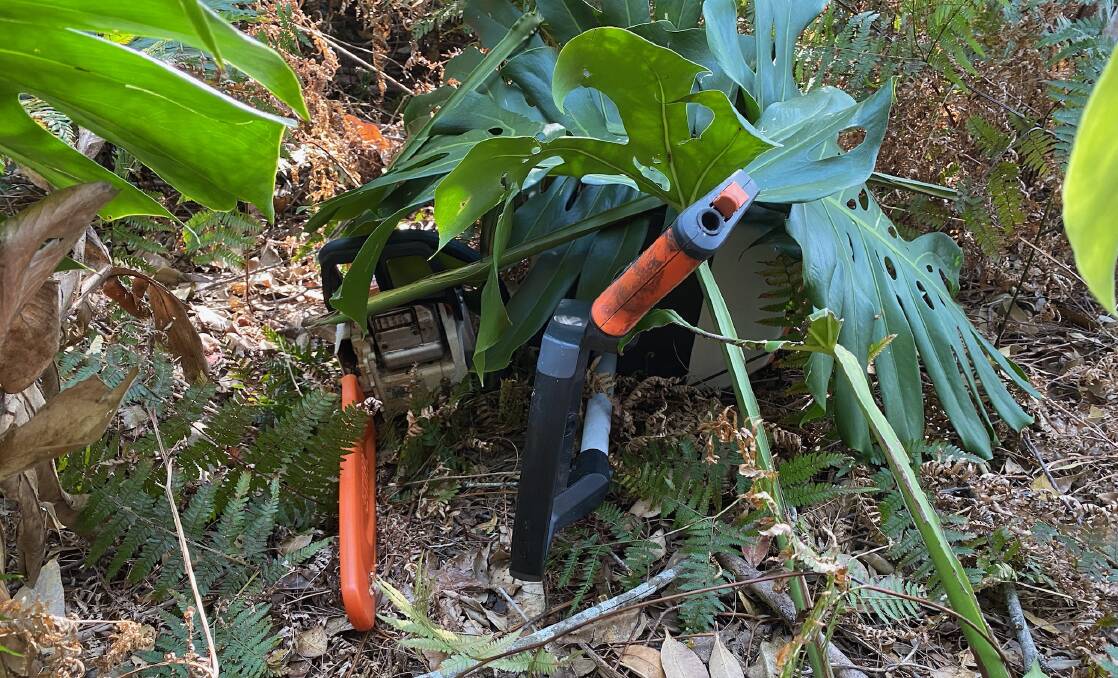 A chainsaw and pressure washer taken from Peter Loveday's home were found in nearby bushland, hidden under leaves. Picture by Glenn Ellard.