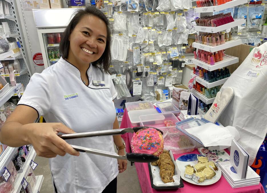 Owner-operator at Nowra's Blooms The Chemist, Jovin Papa-Rhodes, offers up cakes to support the Gidget Foundation and its work tacking perinatal depression. Picture by Glenn Ellard.