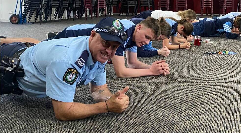 Police officers join local students for a fitness challenge while promoting the IPROWD program. Picture supplied.