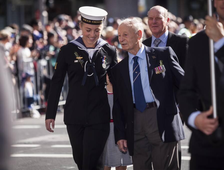 Able Seaman Boatswains Mate Erica Fish marches down Elizabeth Street with her grandfather Cecil Fish during the 2016 Anzac Day march in Sydney, NSW. Photo: Courtesy Defence