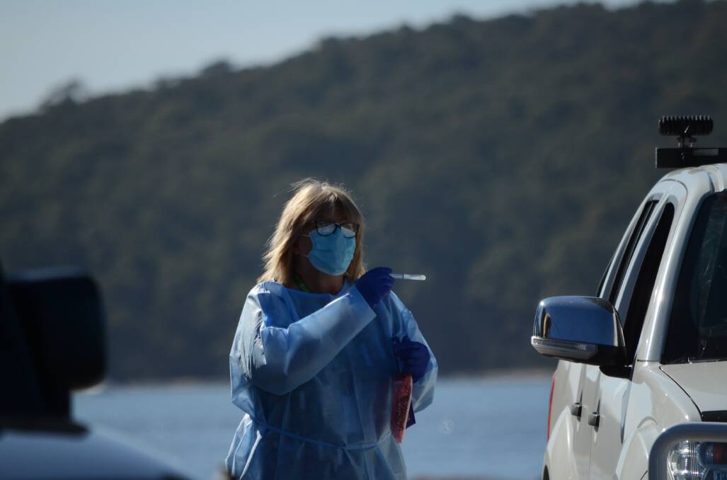 A health worker swabs a patient at the Hanging Rock COVID-19 testing clinic on Wednesday morning, July 22. A visitor to three shire clubs has tested positive to COVID-19. PICTURE: Andrea Cantle.