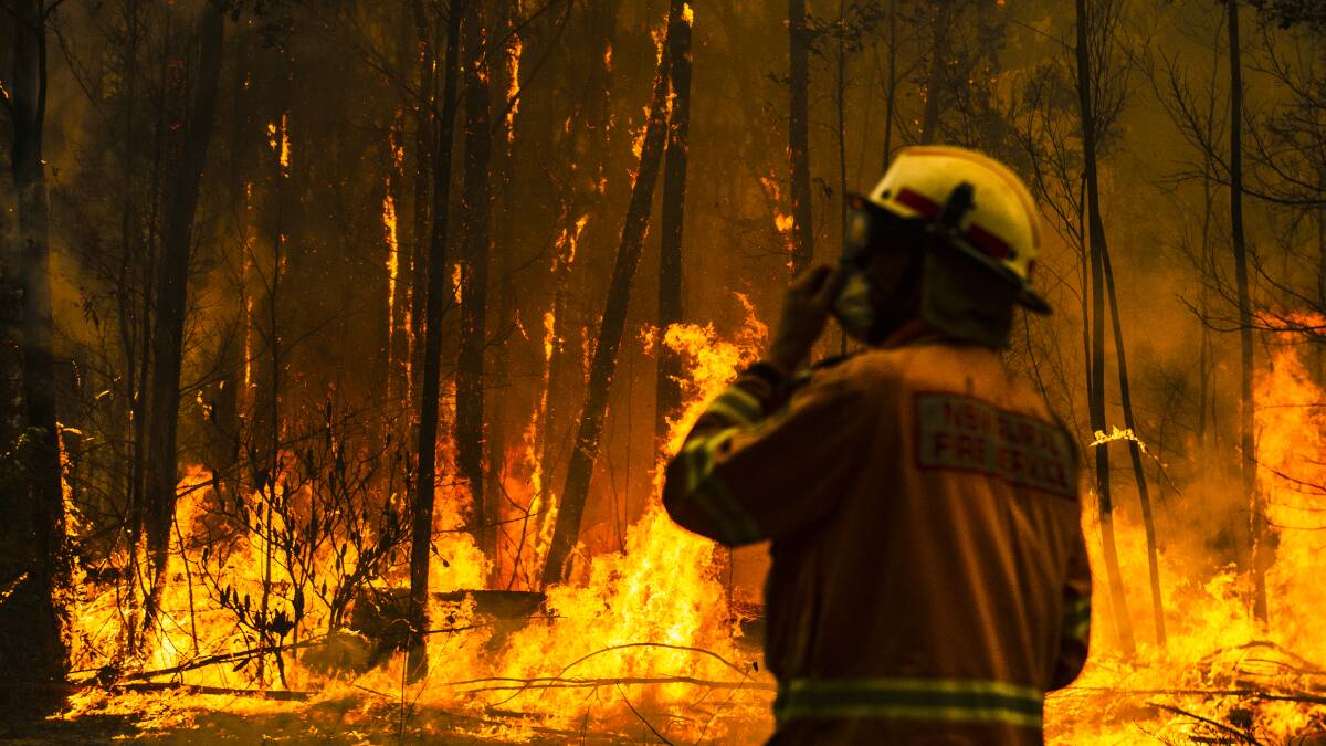 Bushfires burn on the south coast of NSW in December 2019. The fires hit the local economy during its peak tourism season. Picture: Dion Georgopoulos
